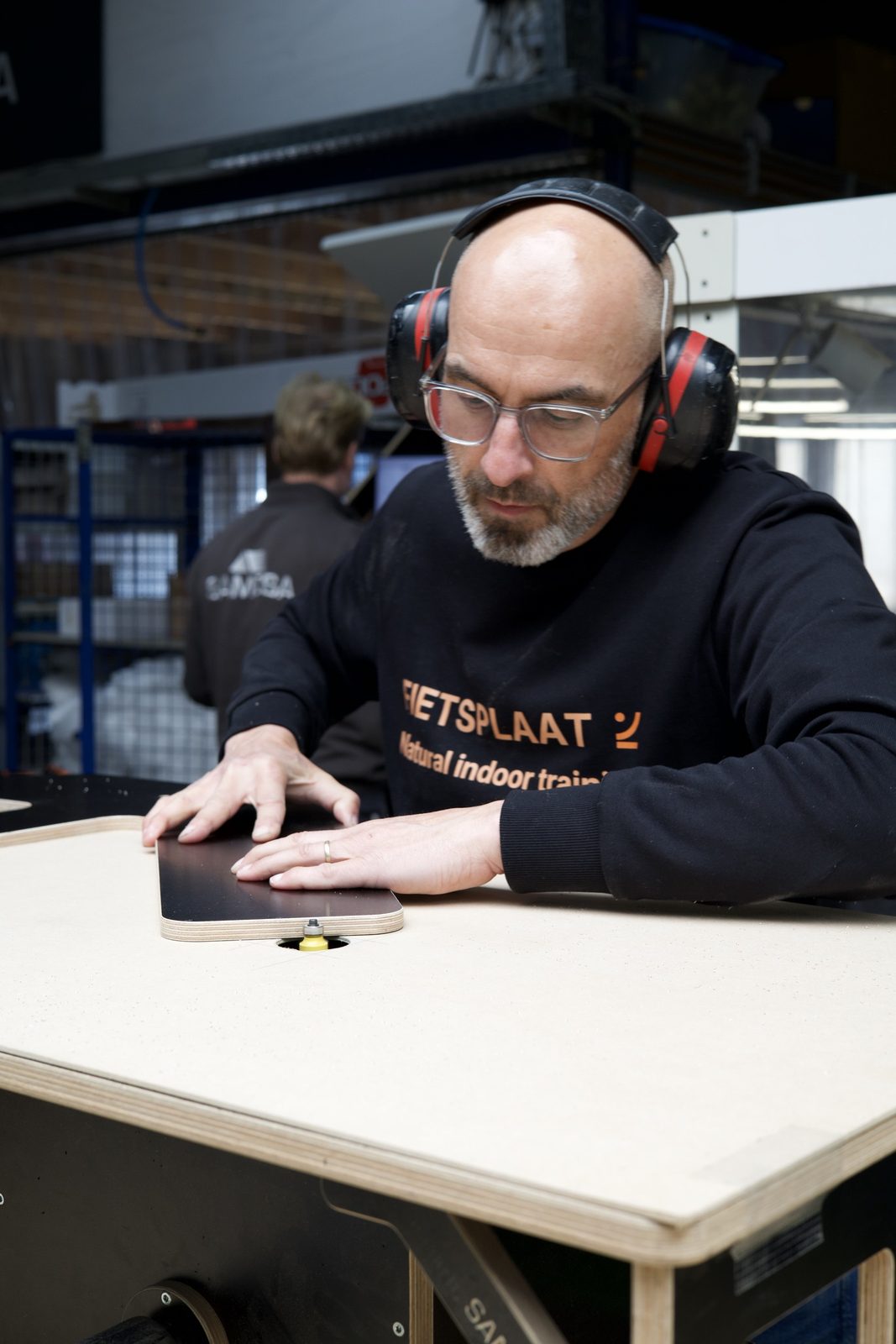 Craftsman checking the finish of a plate