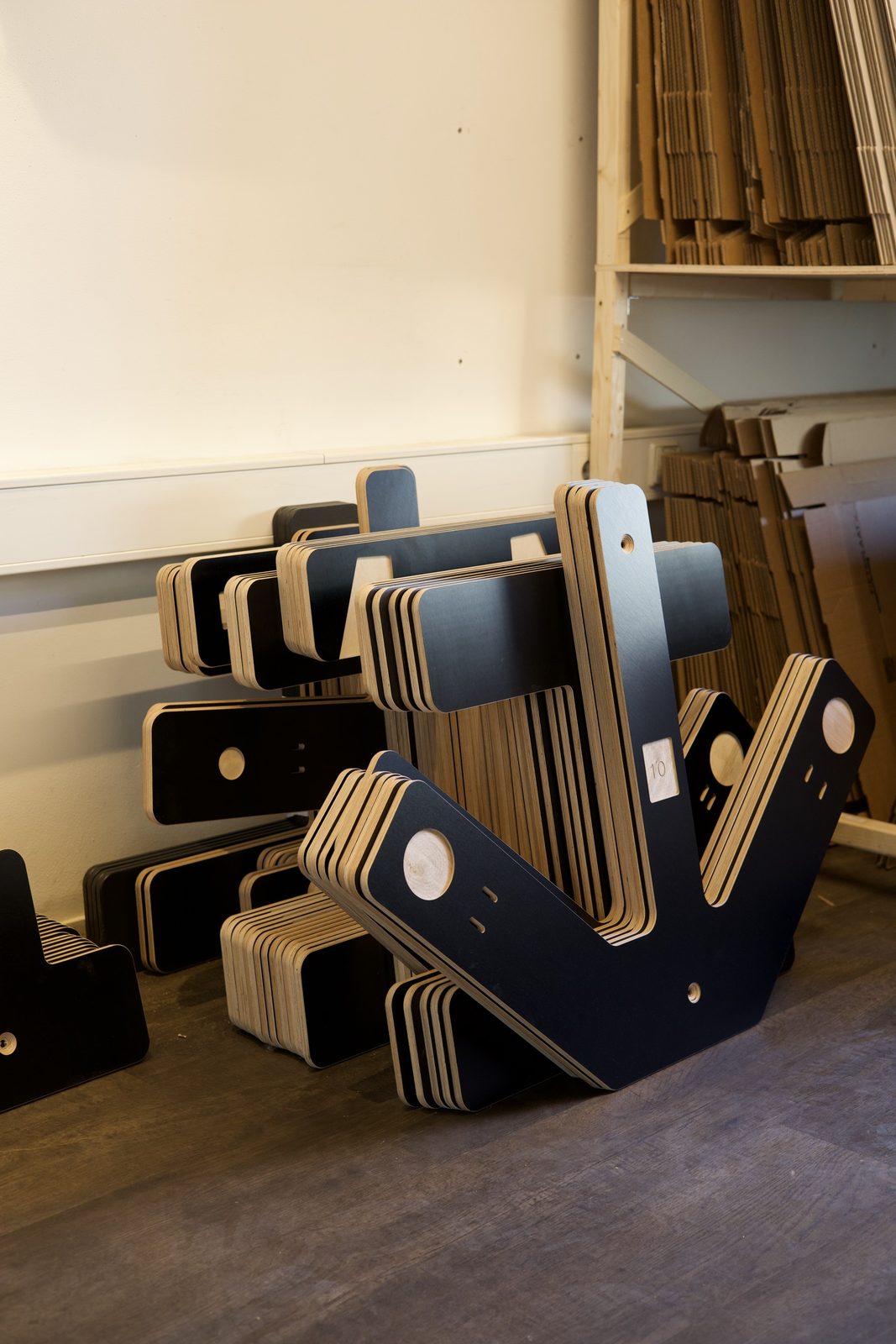 Finished plates with visible wood layers, stacked